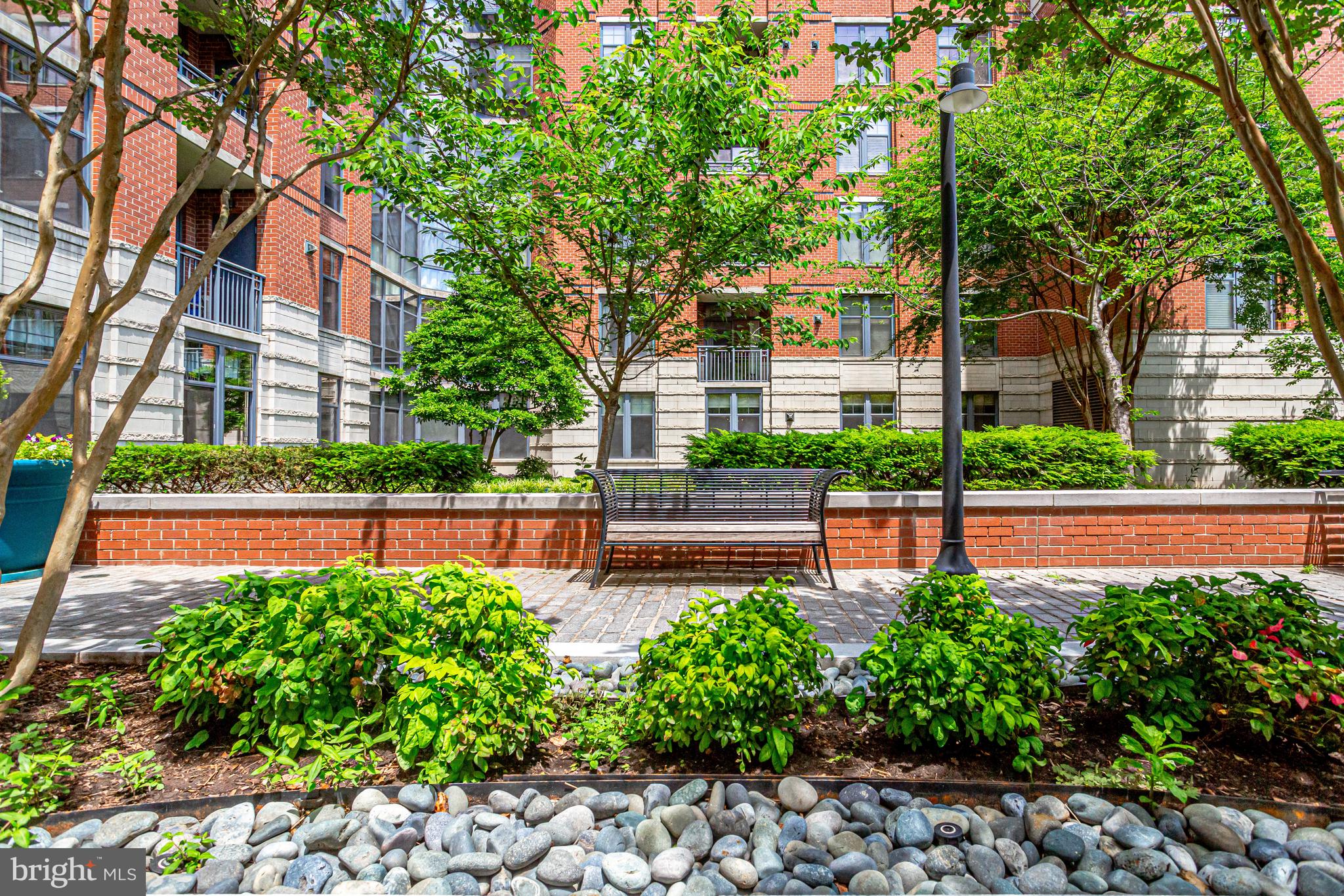 1021 North Garfield Street, Unit 914 Arlington, VA 22201 - Photo 50 of 63 a front view of a house with a yard and table and chairs