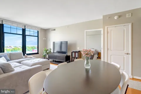 a living room with fireplace furniture and a large window