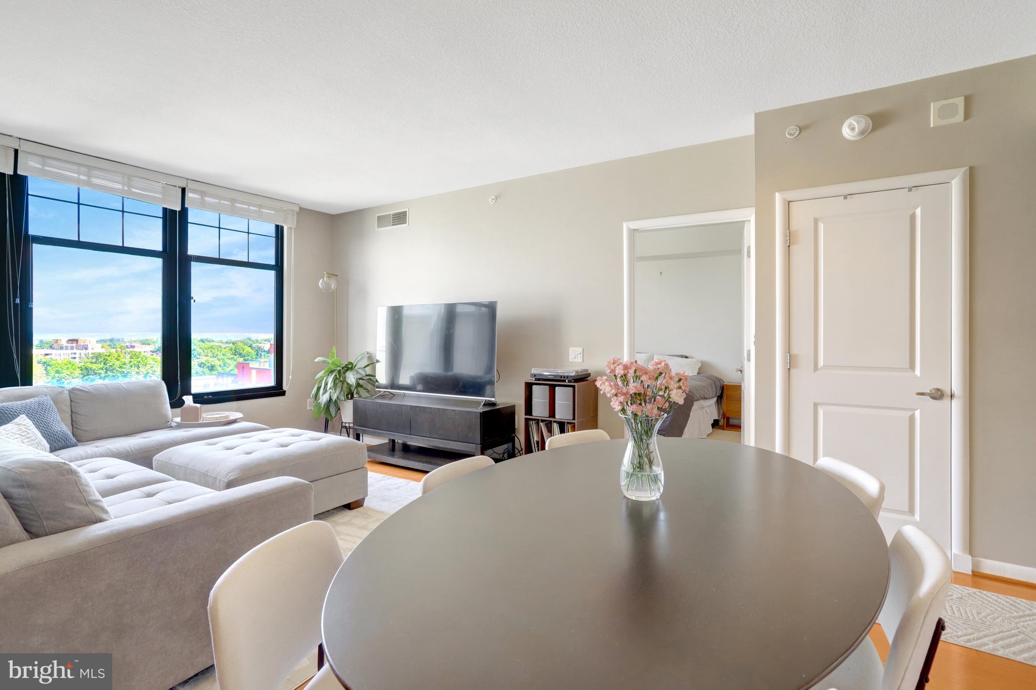 1021 North Garfield Street, Unit 914 Arlington, VA 22201 - Photo 7 of 63 a living room with fireplace furniture and a large window