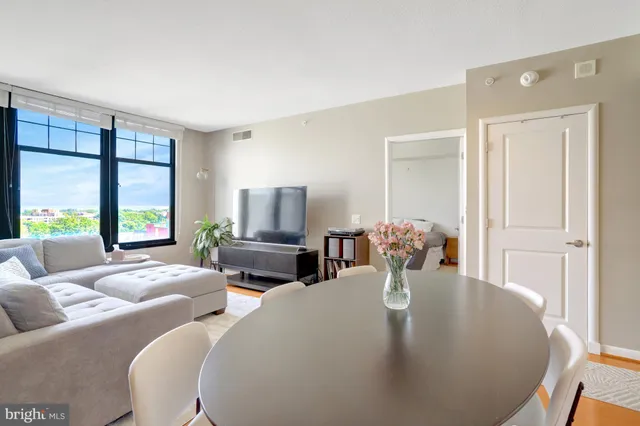 a living room with fireplace furniture and a large window