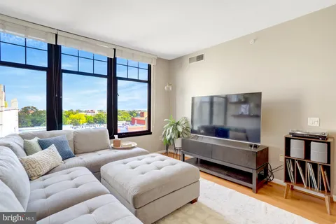 a bedroom with furniture and a large window