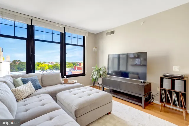a bedroom with furniture and a large window