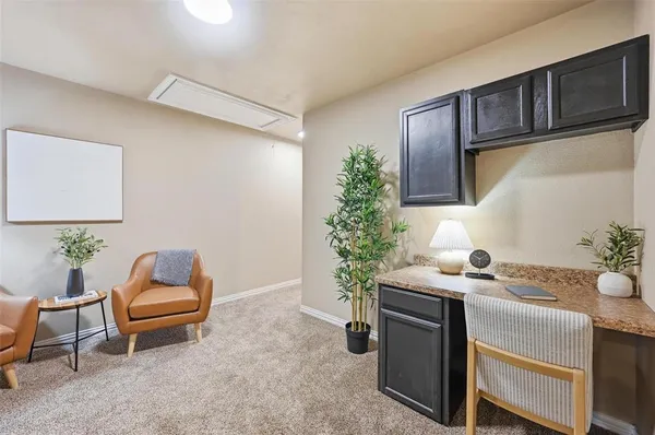 a living room with a couch and potted plant