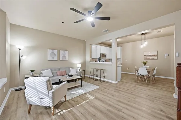 a living room with furniture and a wooden floor