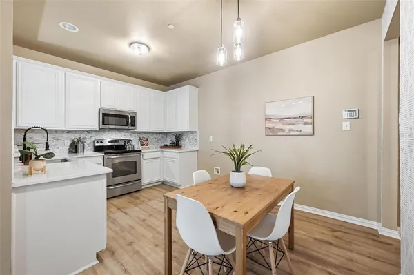 a kitchen with granite countertop counter space a sink appliances and cabinets