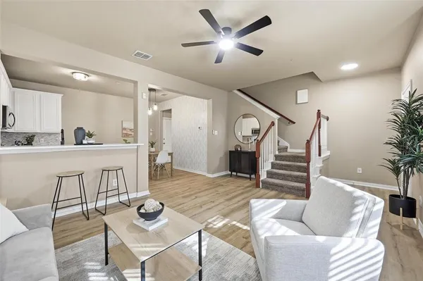 a living room with furniture and kitchen view