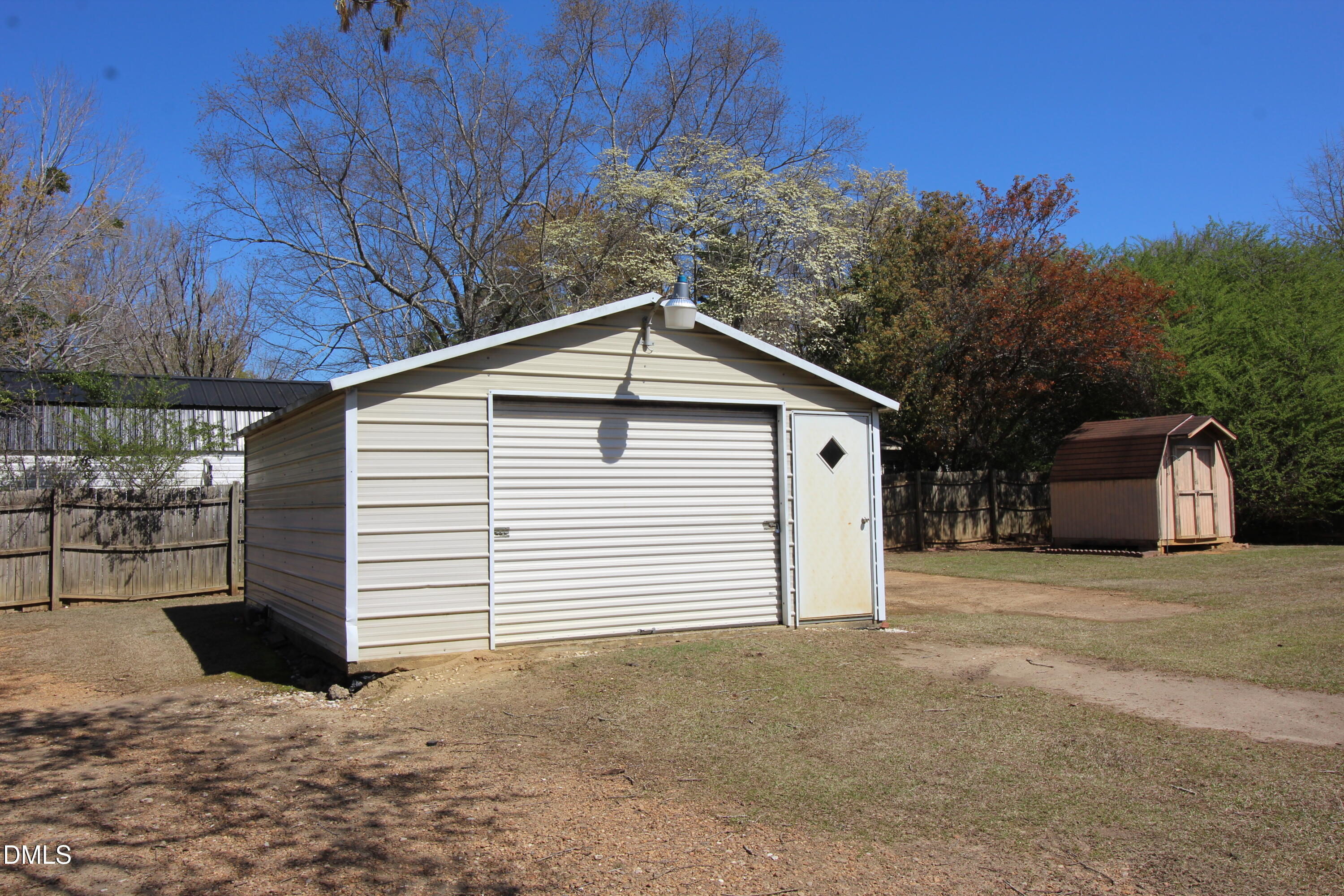 56 Ash Street Coats, NC 27521 - Photo 11 of 28 a view of a house with a yard and garage