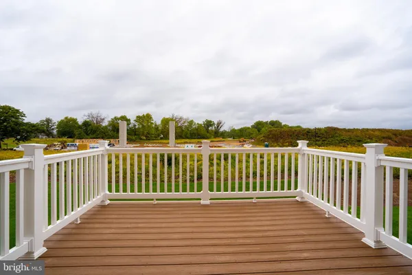 a view of balcony with wooden floor and fence