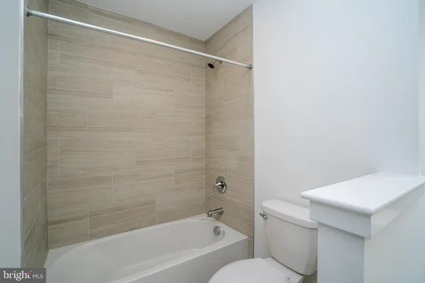 a bathroom with a shower and a toilet