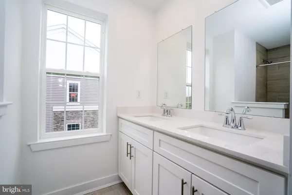 a bathroom with a sink and a window