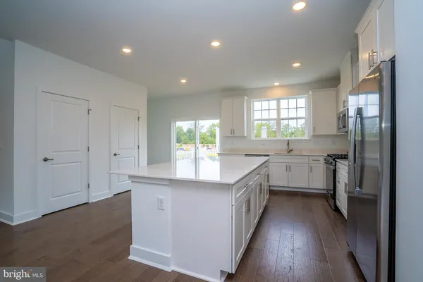 a kitchen with counter top space sink and refrigerator