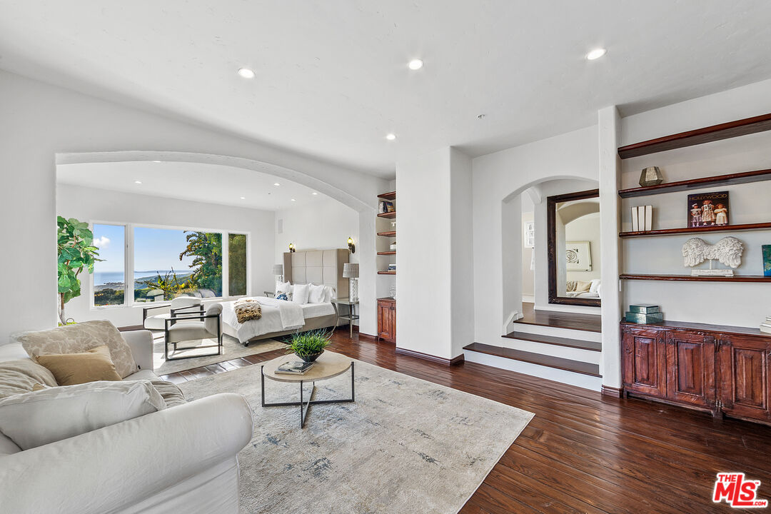 22355 Carbon Mesa Road Malibu, CA 90265 - Photo 35 of 69 a living room with furniture and wooden floor