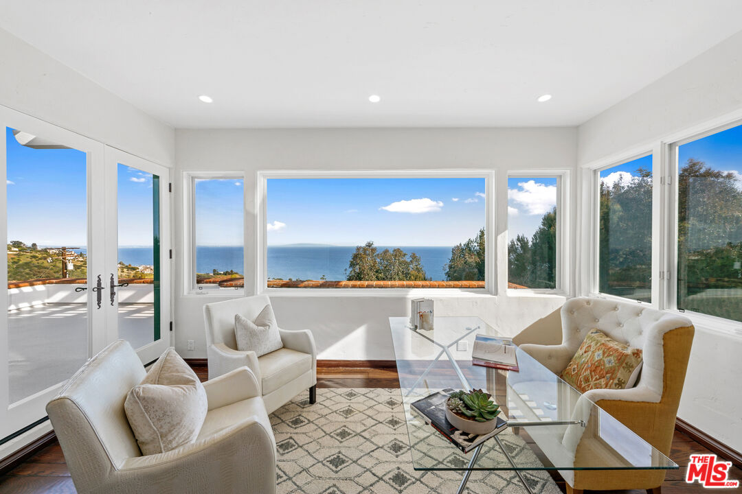 22355 Carbon Mesa Road Malibu, CA 90265 - Photo 43 of 69 a living room with furniture and a large window