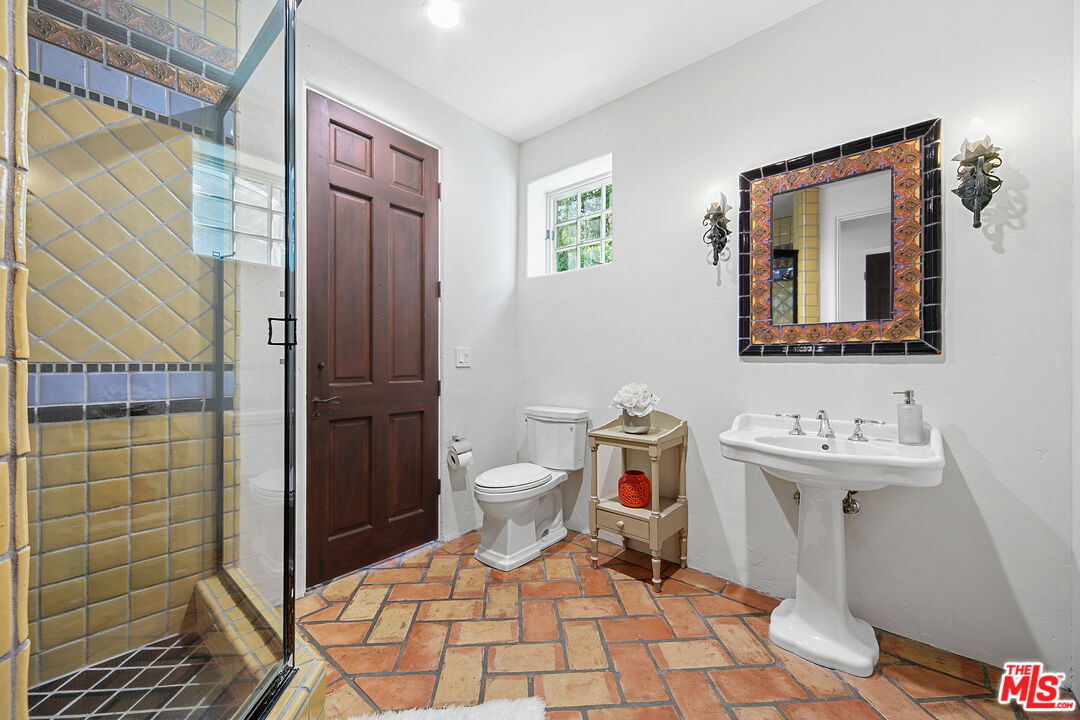 22355 Carbon Mesa Road Malibu, CA 90265 - Photo 50 of 69 a bathroom with a toilet sink and shower
