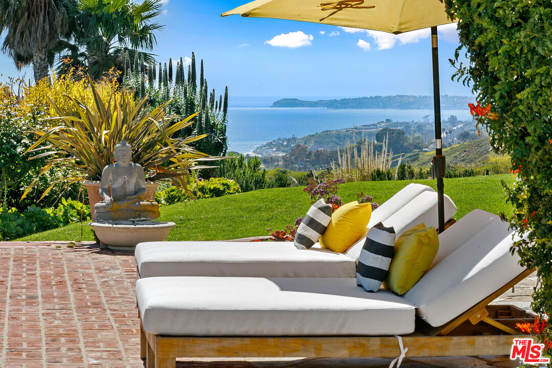 22355 Carbon Mesa Road Malibu, CA 90265 - Photo 7 of 69 a view of a swimming pool with a patio and a yard