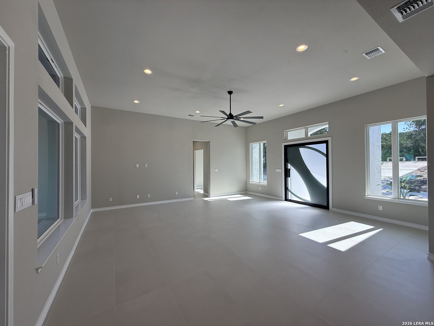 189 Mustang Lane Spring Branch, TX 78070 - Photo 15 of 53 an empty room with windows and ceiling fan