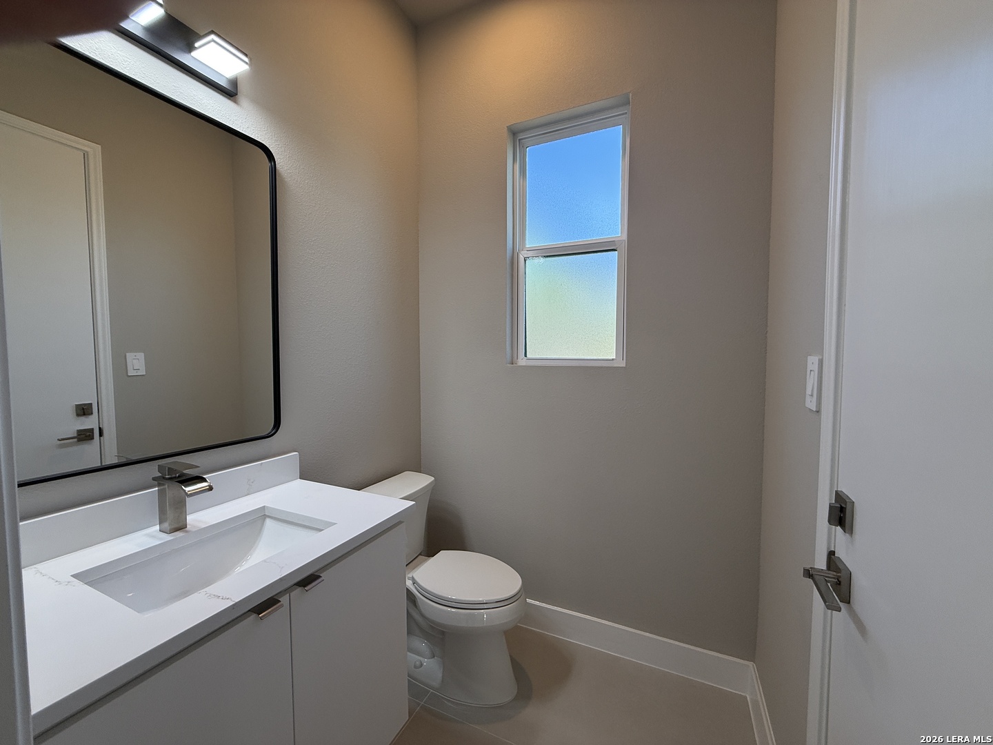 189 Mustang Lane Spring Branch, TX 78070 - Photo 17 of 53 a bathroom with a granite countertop sink a toilet and a mirror