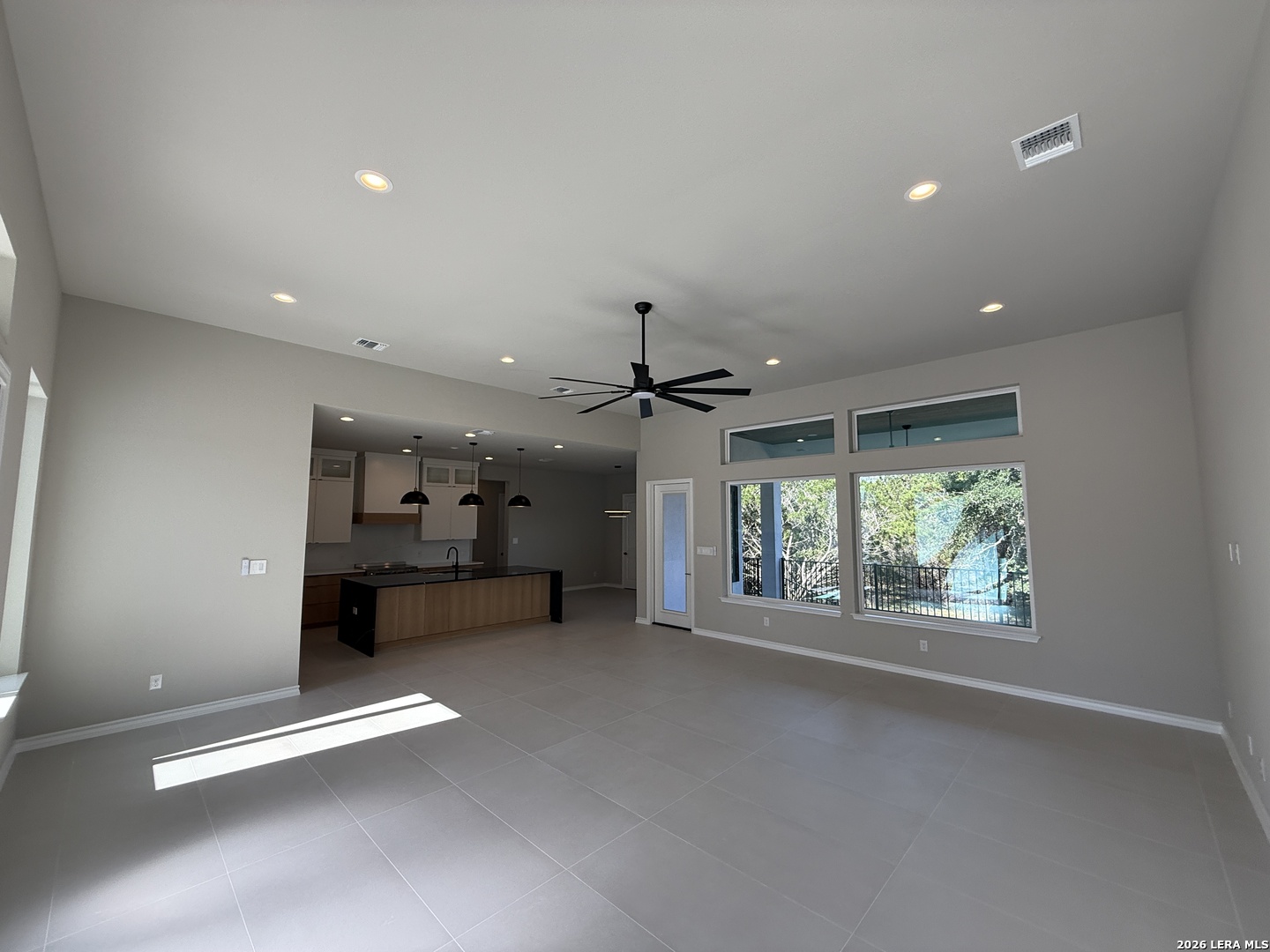 189 Mustang Lane Spring Branch, TX 78070 - Photo 19 of 53 an empty room with windows and ceiling fan