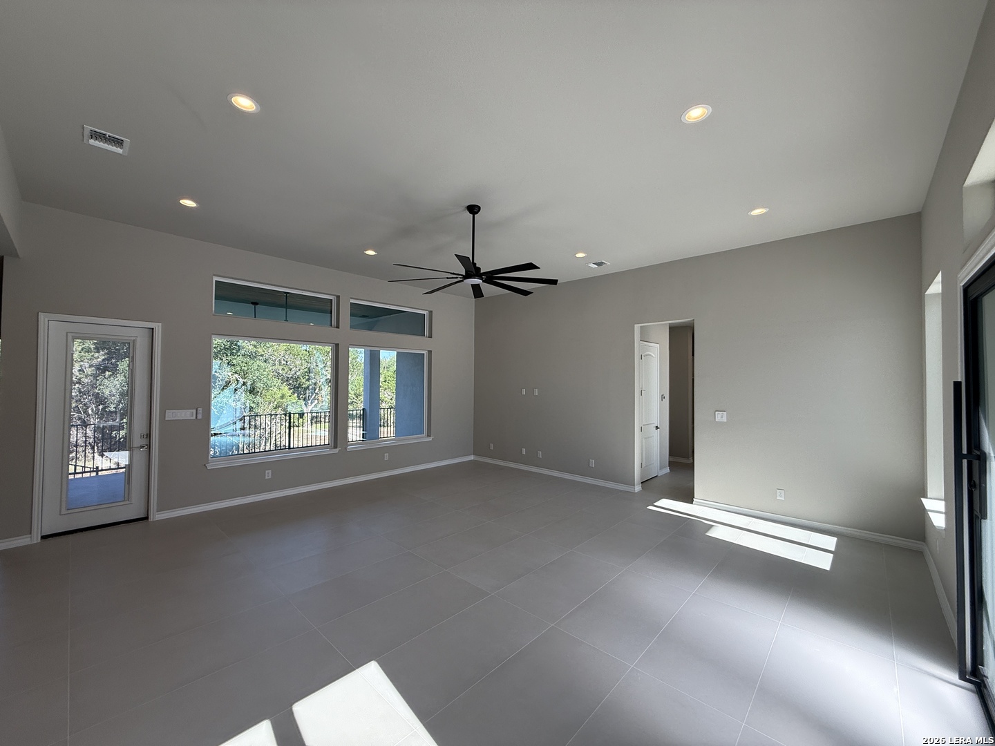 189 Mustang Lane Spring Branch, TX 78070 - Photo 20 of 53 an empty room with windows and ceiling fan
