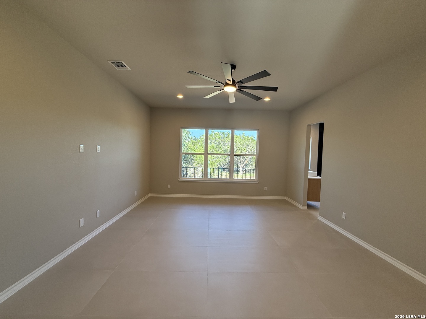 189 Mustang Lane Spring Branch, TX 78070 - Photo 27 of 53 an empty room with chandelier fan and windows