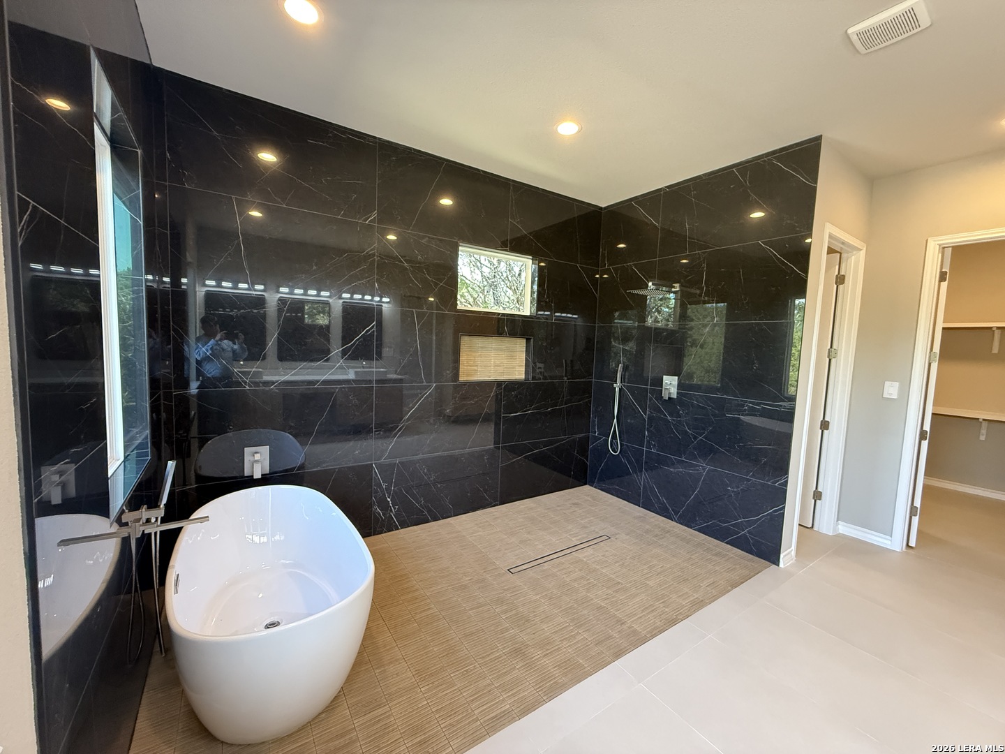 189 Mustang Lane Spring Branch, TX 78070 - Photo 33 of 53 a bathroom with a sink and a mirror