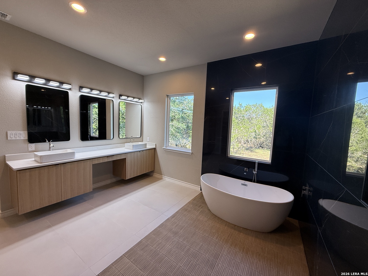 189 Mustang Lane Spring Branch, TX 78070 - Photo 34 of 53 a bathroom with a large tub sink and mirror