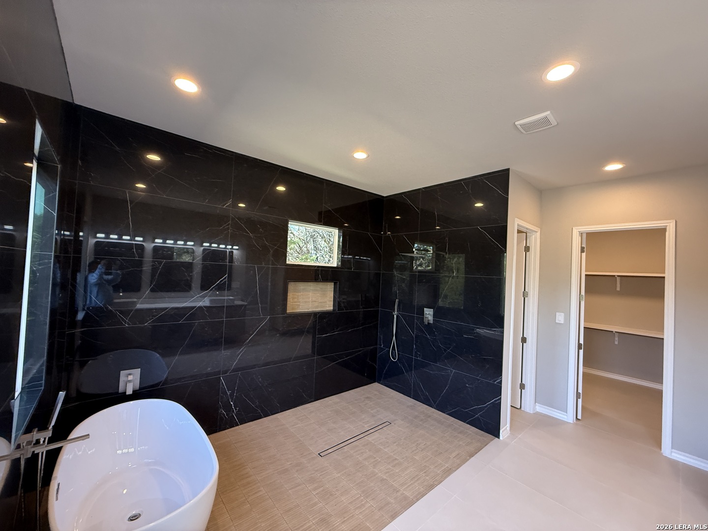 189 Mustang Lane Spring Branch, TX 78070 - Photo 35 of 53 a bathroom with a sink a toilet a mirror and glass door shower