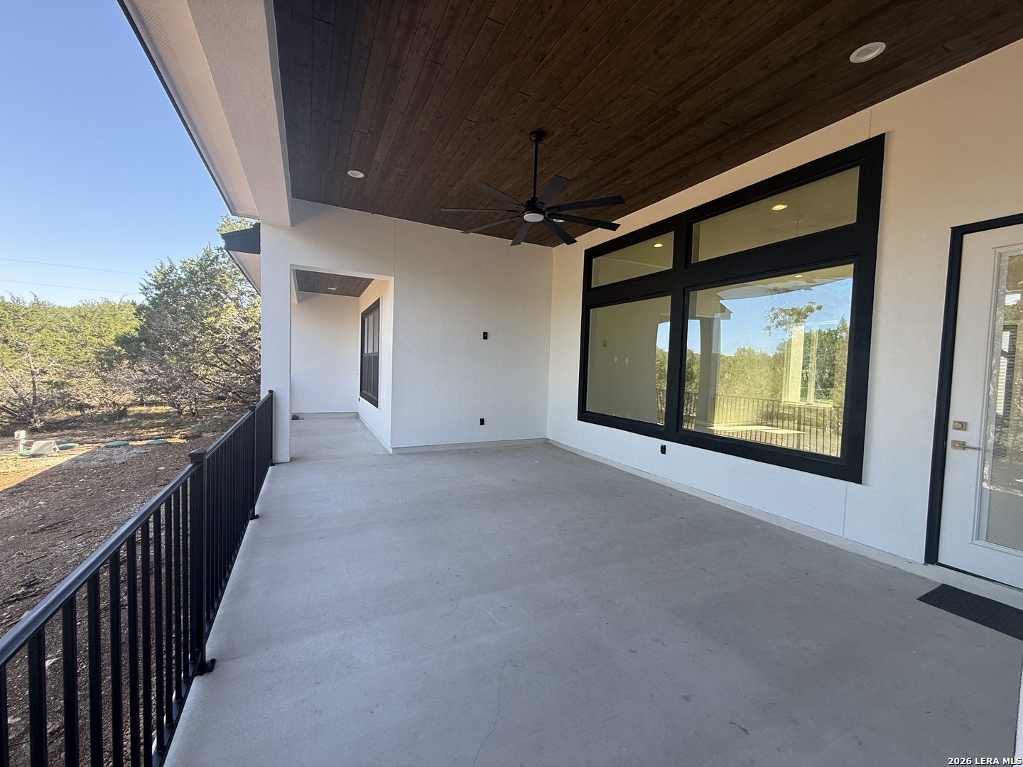 189 Mustang Lane Spring Branch, TX 78070 - Photo 51 of 53 a view of a hallway with wooden floor and fence