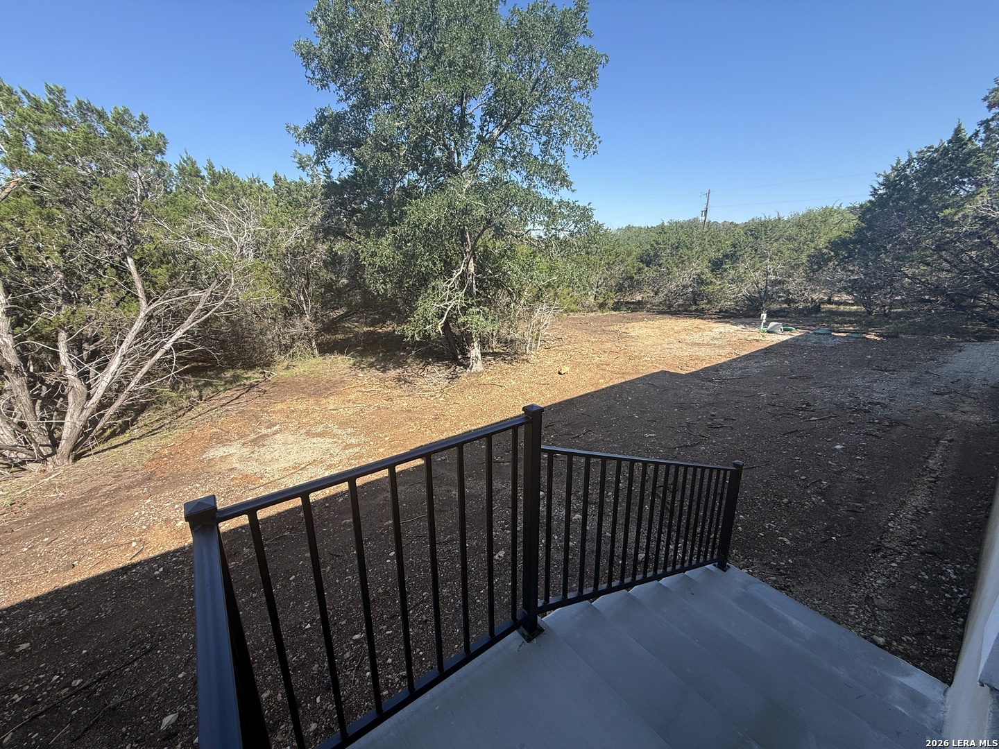 189 Mustang Lane Spring Branch, TX 78070 - Photo 53 of 53 a balcony with wooden floor and yard in the back