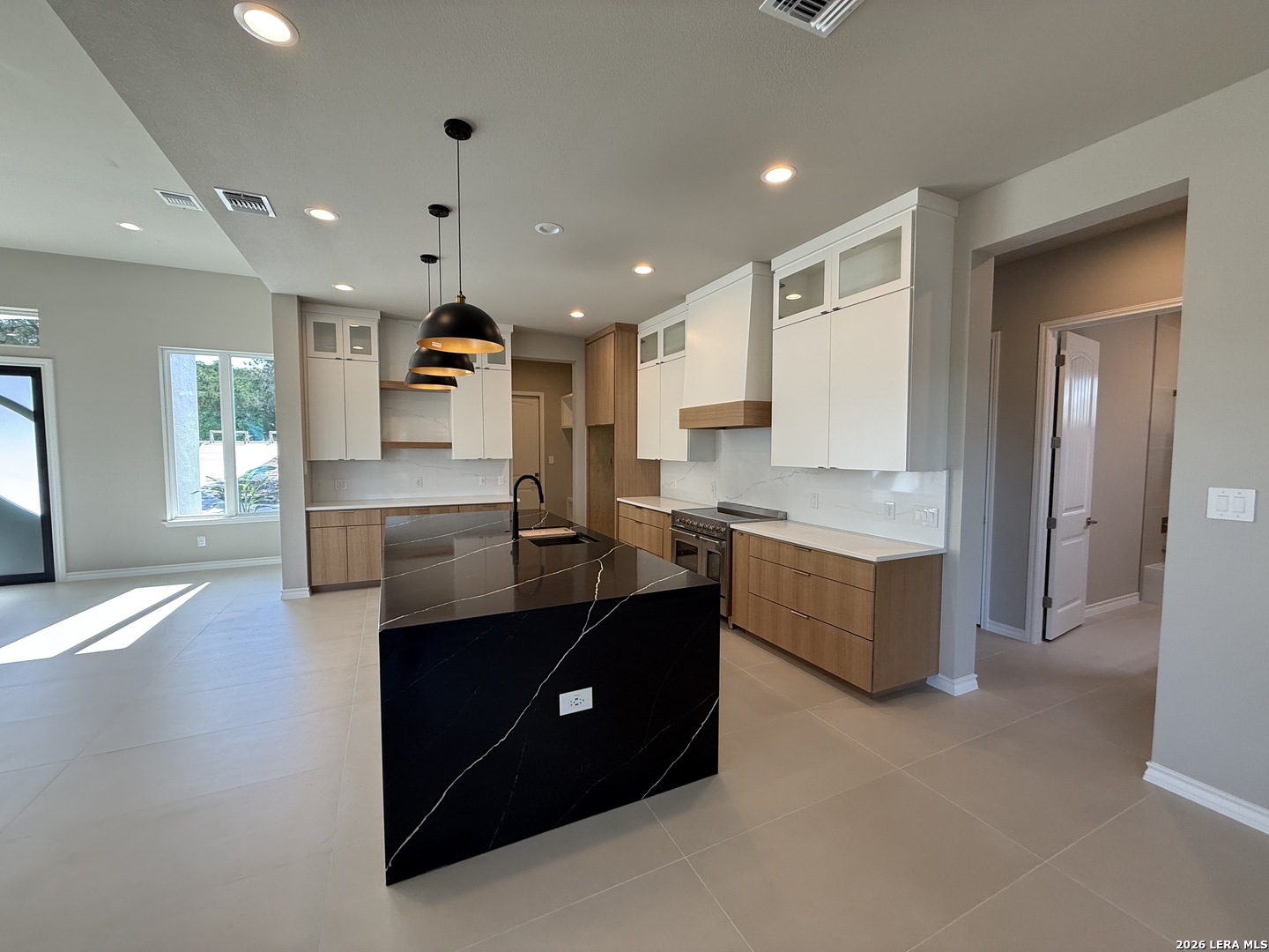 189 Mustang Lane Spring Branch, TX 78070 - Photo 6 of 53 a large kitchen with a large counter top a sink stainless steel appliances and cabinets