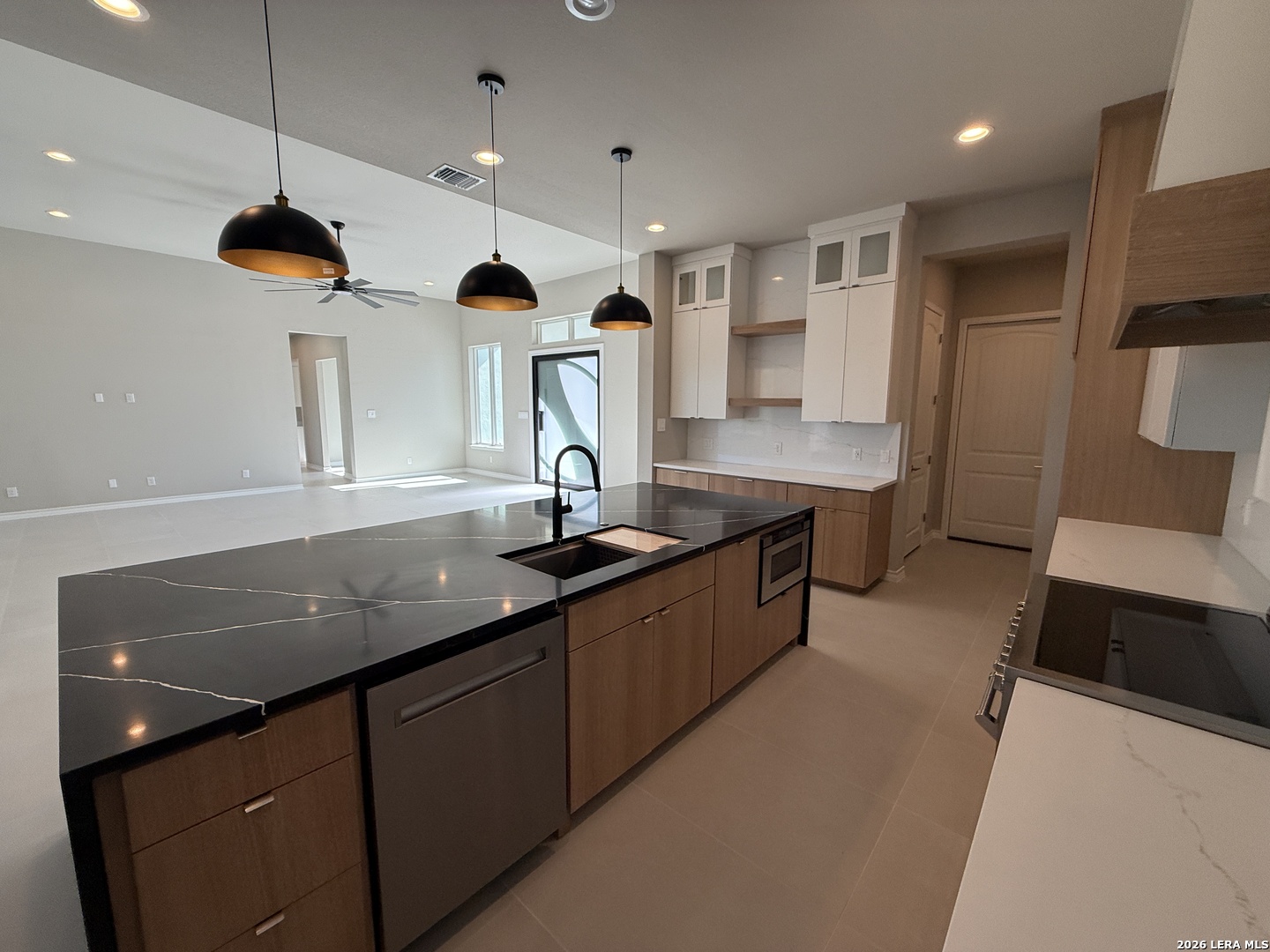 189 Mustang Lane Spring Branch, TX 78070 - Photo 9 of 53 a kitchen with stainless steel appliances granite countertop a sink a stove and a refrigerator