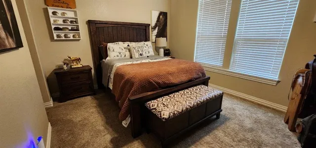 a bed sitting in a bedroom next to a window