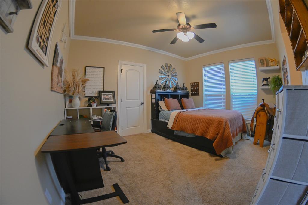 1397 Cr 338 Gainesville Tx 76240 Gainesville, TX 76240 - Photo 24 of 36 a bedroom with a bed a desk and chair