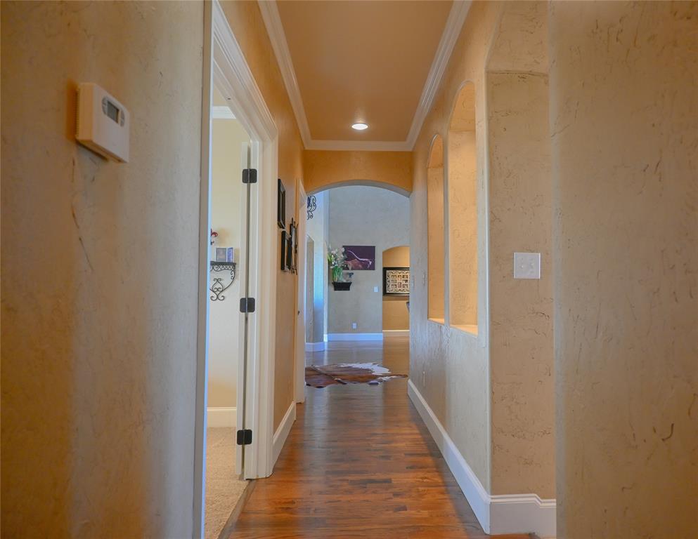 1397 Cr 338 Gainesville Tx 76240 Gainesville, TX 76240 - Photo 25 of 36 a view of a hallway with wooden floor