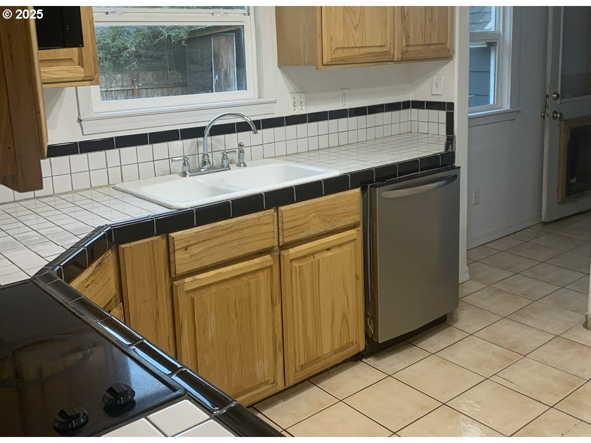 431 Southwest 3rd Avenue Canby, OR 97013 - Photo 11 of 14 a kitchen with a sink and a refrigerator