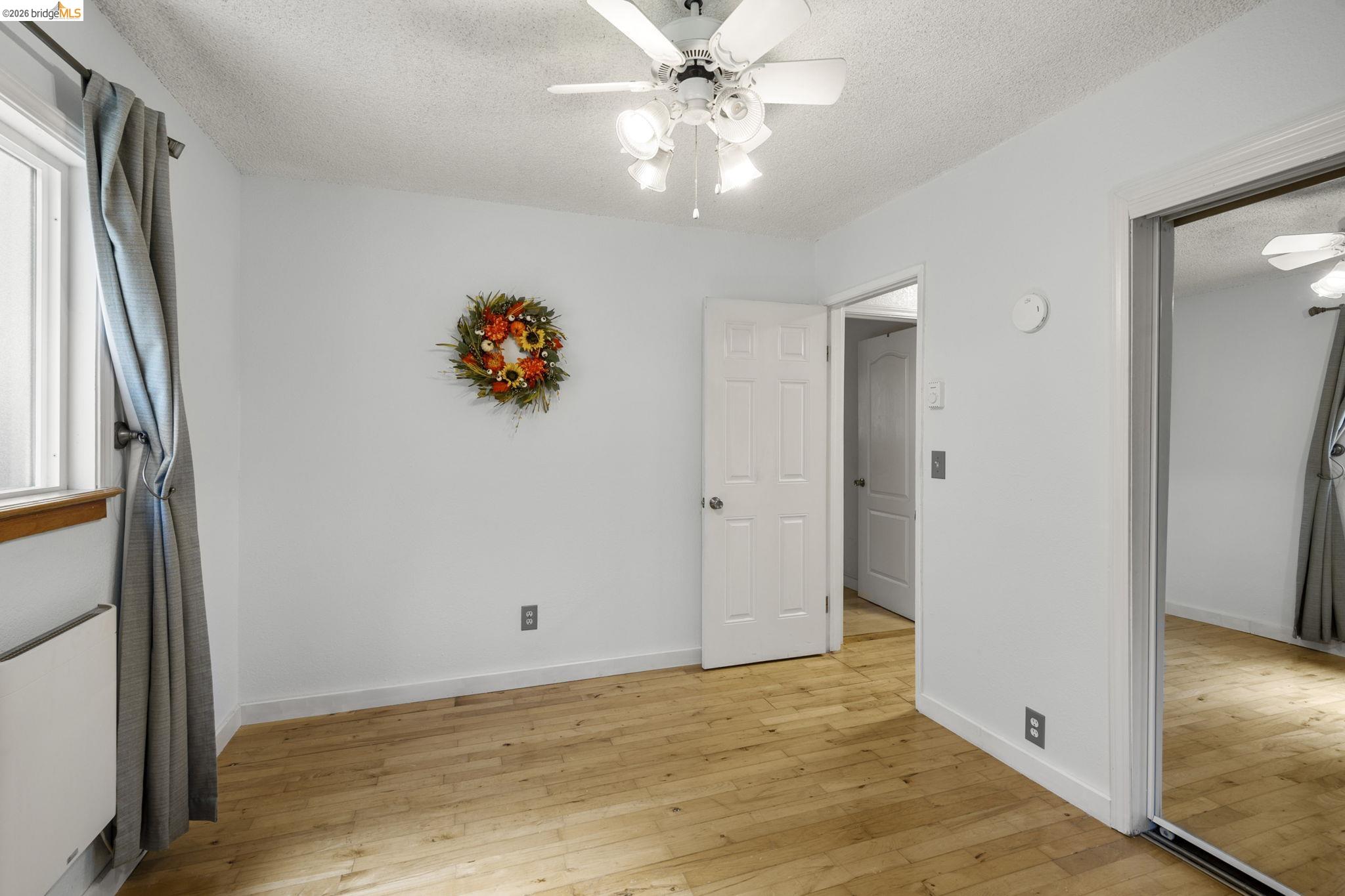 21931 Glenwood Road Sonora, CA 95370 - Photo 23 of 42 a view of an empty room with wooden floor and a window