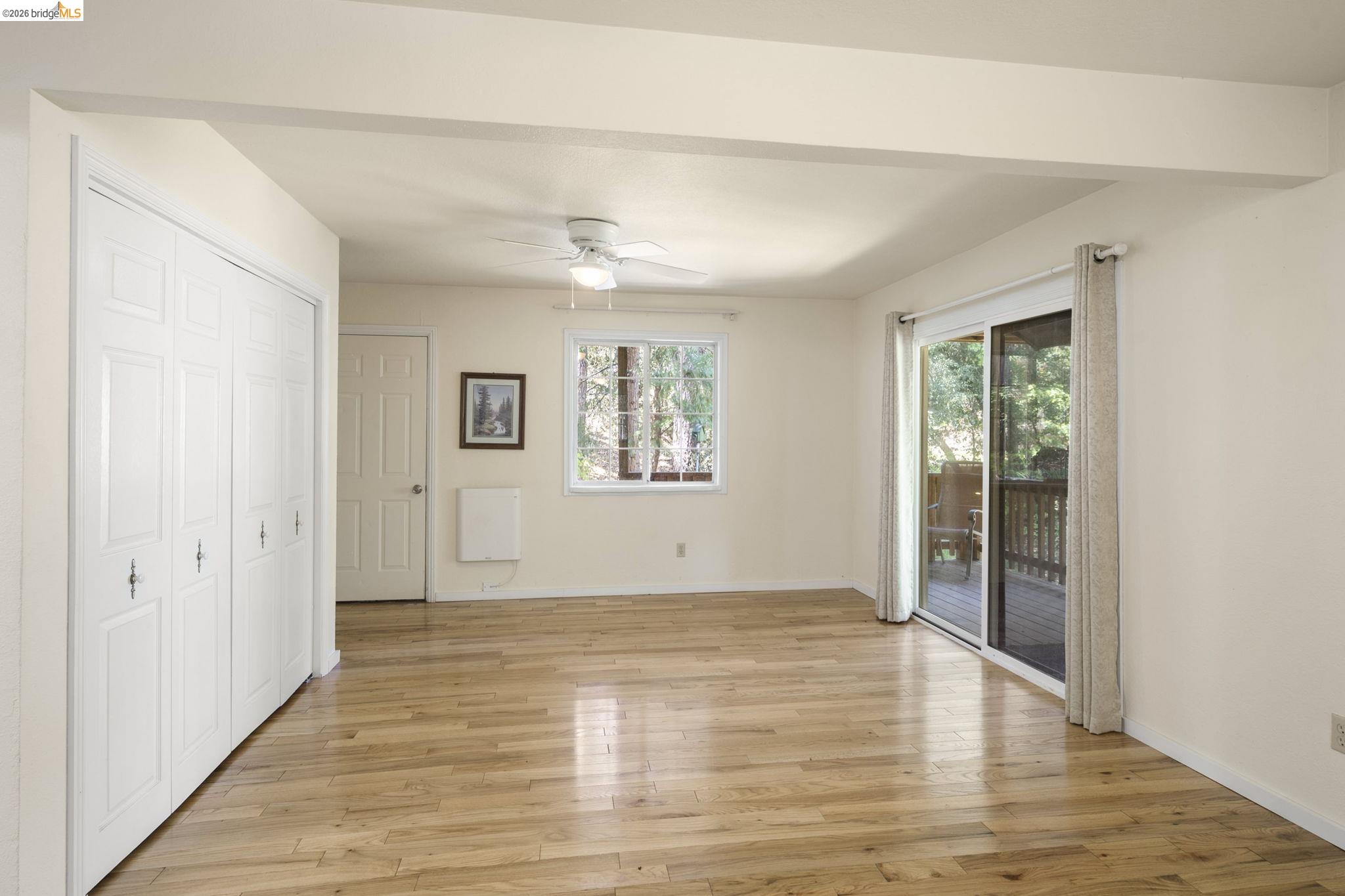 21931 Glenwood Road Sonora, CA 95370 - Photo 27 of 42 a view of an empty room with wooden floor and a window