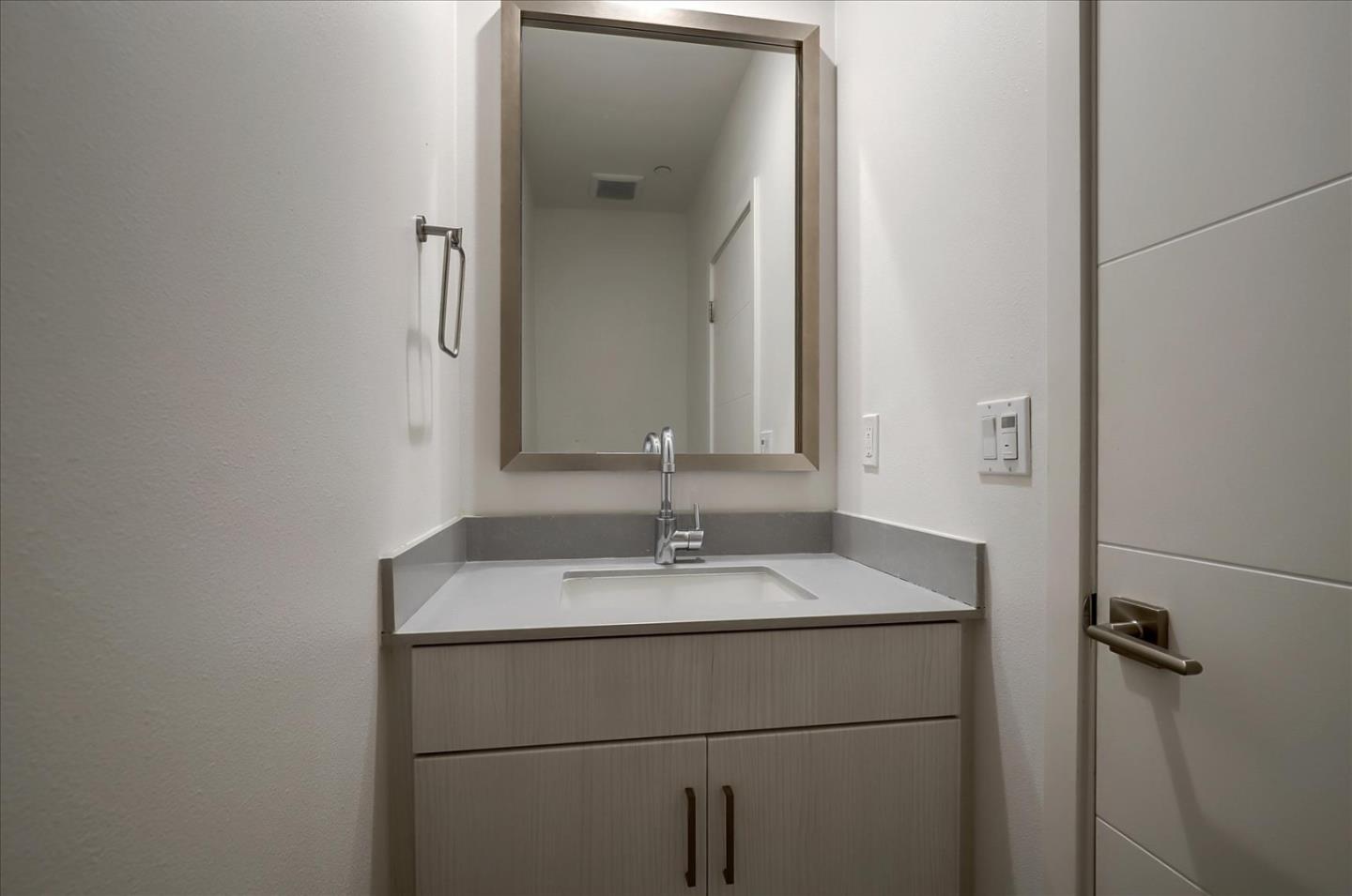 1405 Pullman Way Oakland, CA 94607 - Photo 27 of 36 a bathroom with a sink and a mirror
