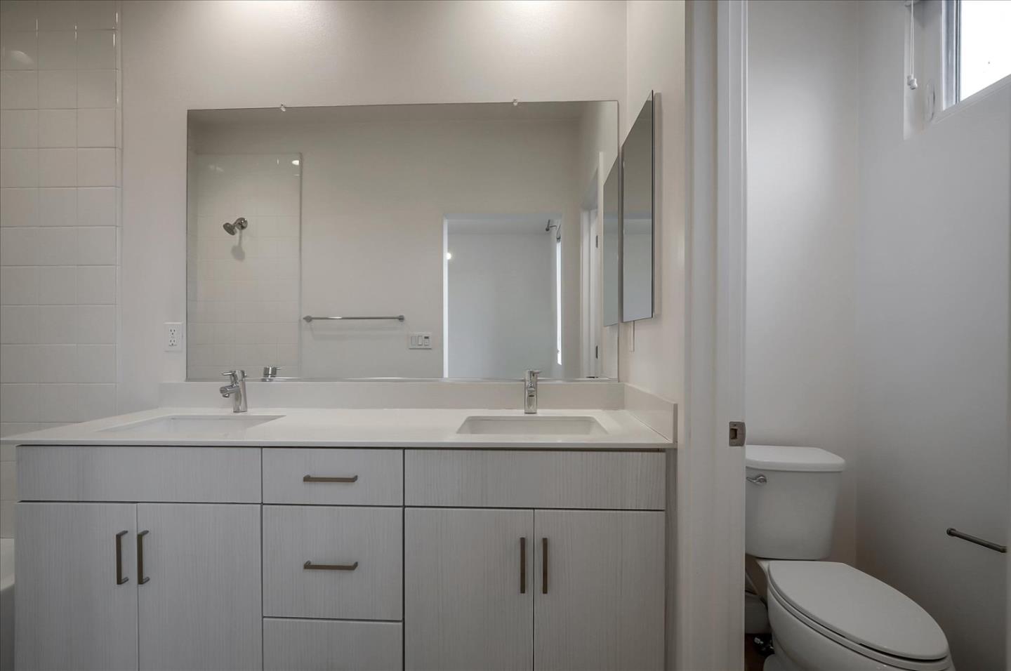 1405 Pullman Way Oakland, CA 94607 - Photo 29 of 36 a bathroom with a sink toilet and mirror
