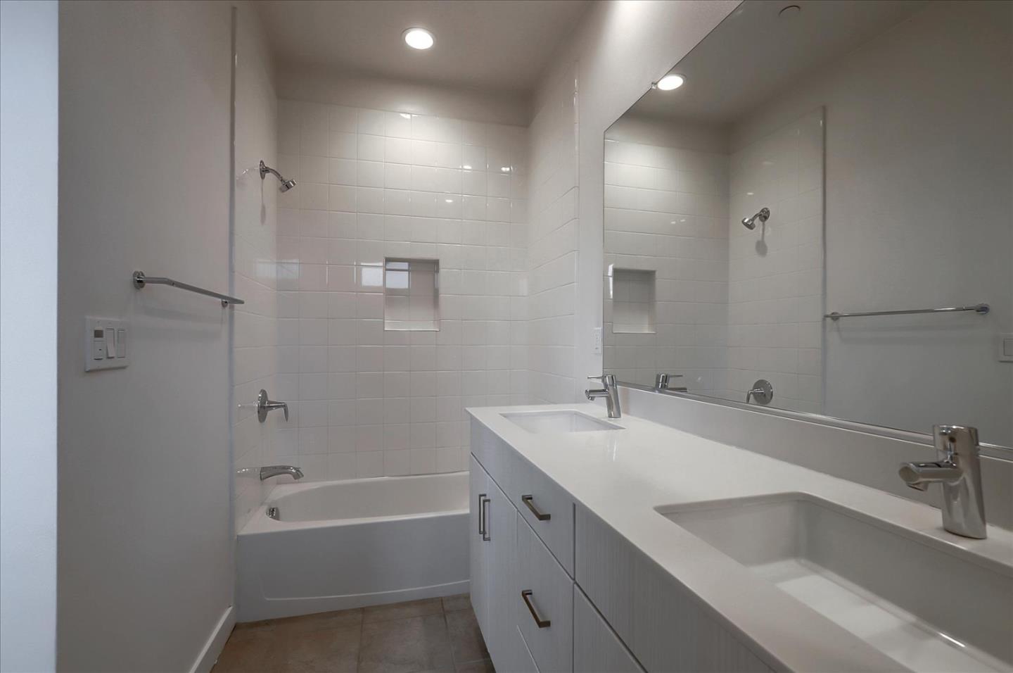 1405 Pullman Way Oakland, CA 94607 - Photo 30 of 36 a bathroom with a tub sink shower and two mirror