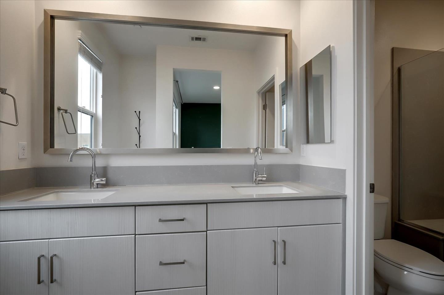 1405 Pullman Way Oakland, CA 94607 - Photo 31 of 36 a bathroom with a double vanity sink and a mirror