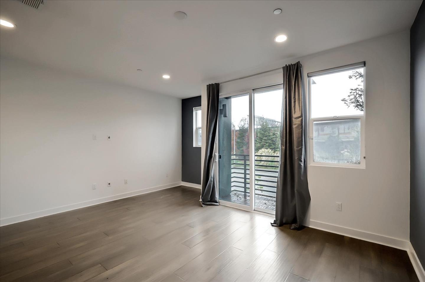 1405 Pullman Way Oakland, CA 94607 - Photo 10 of 36 an empty room with wooden floor and door