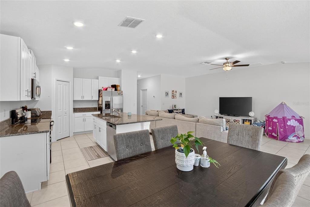 1748 Red Loop Lakeland, FL 33801 - Photo 12 of 66 a living room with kitchen island furniture and a flat screen tv