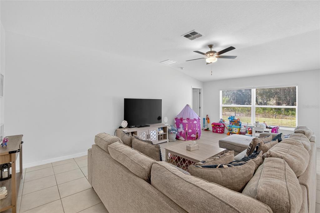 1748 Red Loop Lakeland, FL 33801 - Photo 17 of 66 a living room with furniture and a flat screen tv