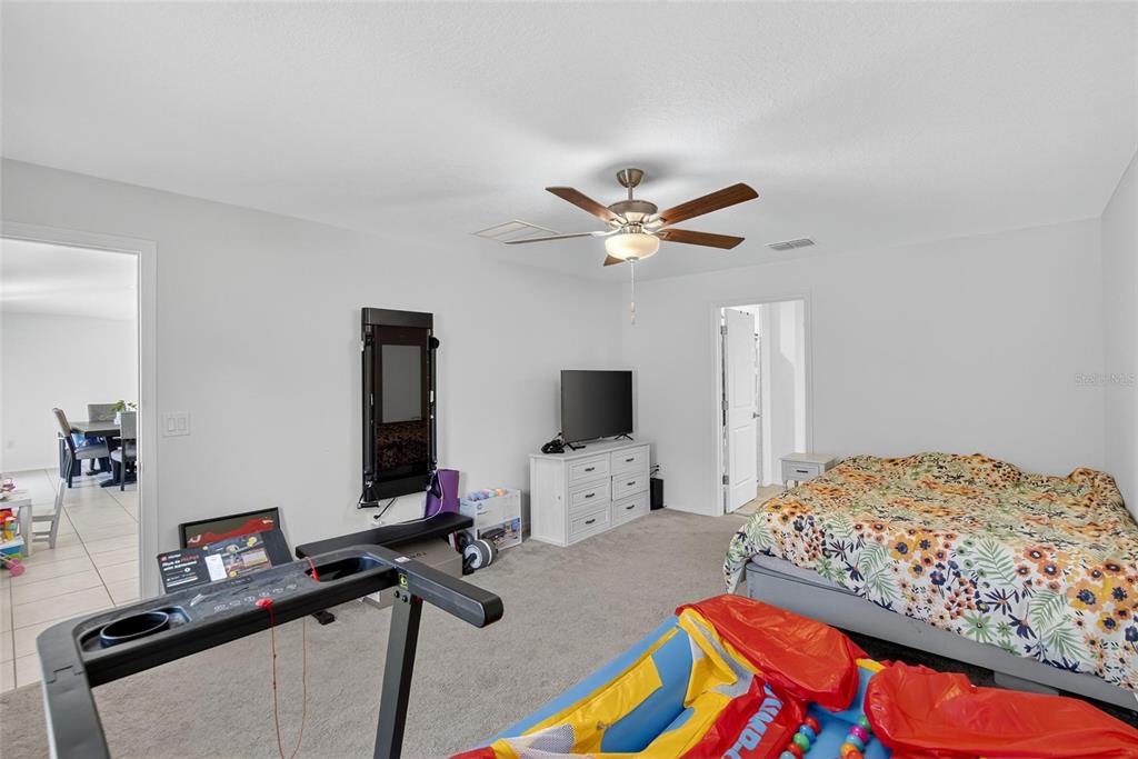 1748 Red Loop Lakeland, FL 33801 - Photo 19 of 66 a bedroom with bed and a flat screen tv