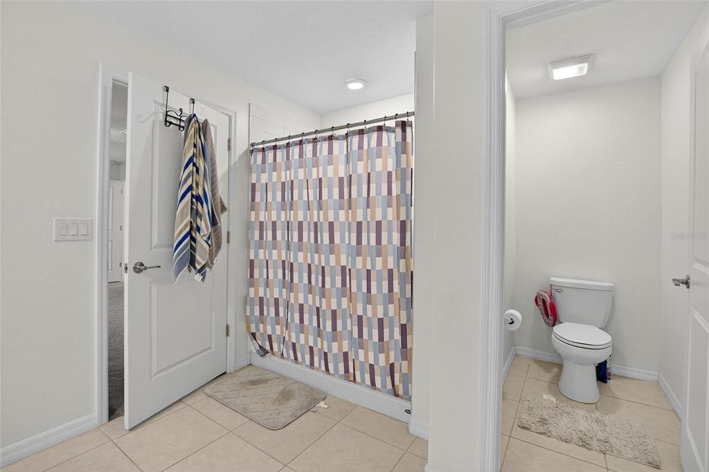 1748 Red Loop Lakeland, FL 33801 - Photo 22 of 66 a bathroom with a toilet and a shower
