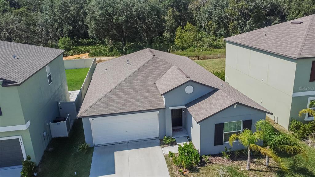 1748 Red Loop Lakeland, FL 33801 - Photo 47 of 66 a aerial view of a house with a yard and potted plants
