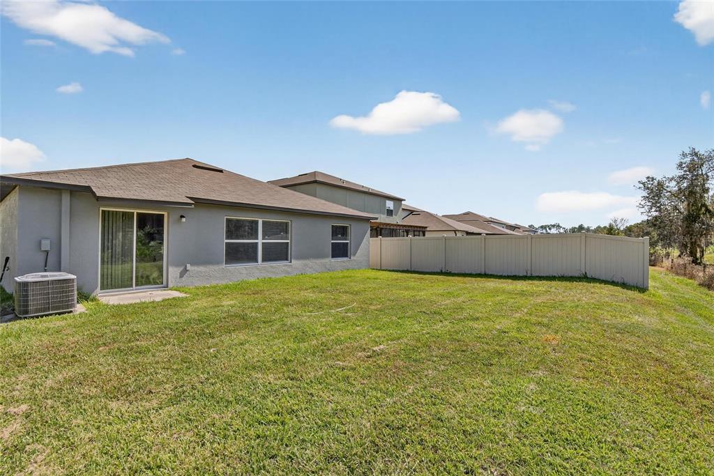 1748 Red Loop Lakeland, FL 33801 - Photo 5 of 66 a view of a house with a backyard and a tree