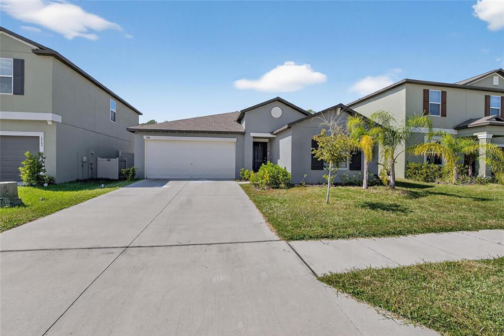 1748 Red Loop Lakeland, FL 33801 - Photo 54 of 66 a front view of a house with a yard and garage