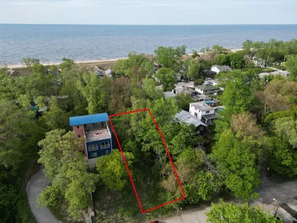 an aerial view of a house with a yard and lake view
